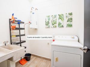 a kitchen with a sink and a dishwasher at Casa de la Armonia - Andares in Zapopan +26 photos