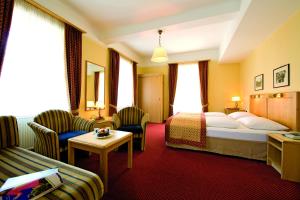 una camera d'albergo con un letto e un divano di Hotel Gisela a Bad Gastein