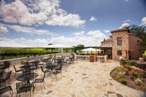 a patio with tables and chairs in front of a building at The Container Retreat @ 290 Wine Trail #9 Get away today! in Hye