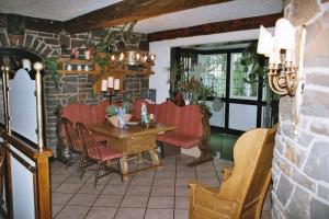 a dining room with a table and red chairs at Hotel Meyer in Kürten