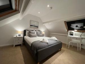 a bedroom with a bed and a sink in it at Jackfield Old School in Coalport