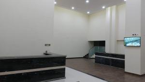 a large room with a flat screen tv on a wall at قصر اباهي للوحدات السكنية in Al Jubail
