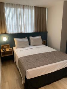 a bedroom with a large bed in a room at Regency Copacabana Hotel in Rio de Janeiro