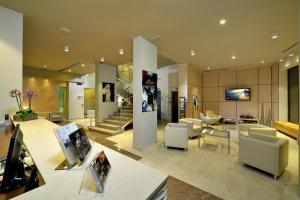 a living room with couches and chairs and a lobby at Hotel Carlton in Ferrara