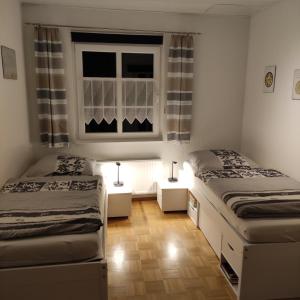 two beds in a room with a window at FEWO Hückeswagen "Das Historische" in Hückeswagen