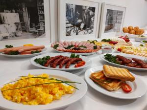 a table with many plates of food on it at Apartamenty ApartArt Zakopane in Zakopane