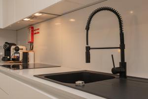 un bancone della cucina con lavandino e rubinetto di Stylish Apartment W/ River View by LovelyStay a Oeiras Altre 32 foto