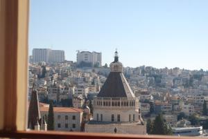 a view of a city from a window at Seedi Yousef Hostel & Cafe in Nazareth