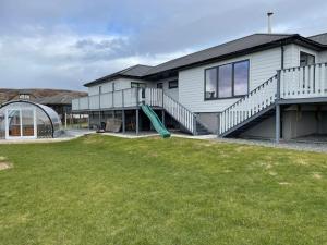 a house with a slide in front of a yard at Wasterview, Central Mainland, Ideal base in Lerwick