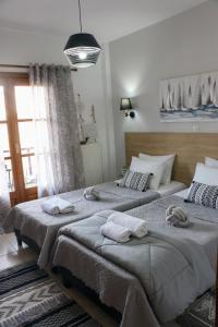 two beds in a bedroom with towels on them at Villa Evgenia(Leonidas) in Ierissos