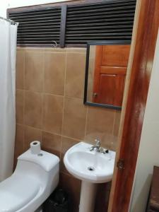 a bathroom with a sink and a toilet and a mirror at Sol de la India - Pueblo Nuevo in Pueblo Nuevo