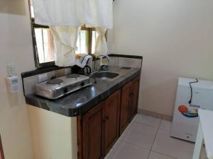 a kitchen counter with a sink and a window at Sol de la India - Pueblo Nuevo in Pueblo Nuevo