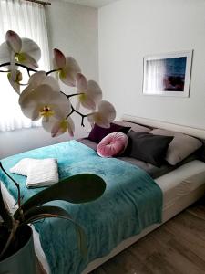 Un dormitorio con una cama con una planta. en Happy Apartments, en Balatonlelle