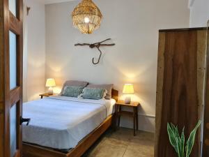 a bedroom with a bed and a chandelier at Trebolmar Apartments for remote work in Santa Teresa Beach