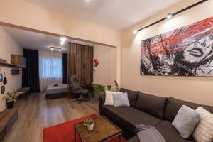 a living room with a couch and a bedroom at The Red Point in Varna City +14 photos