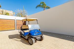 a golf cart with a canopy on a patio at Cerritos Surf Residences in El Pescadero