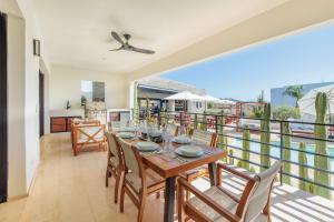 a dining room with a table and chairs on a balcony at Cerritos Surf Residences in El Pescadero