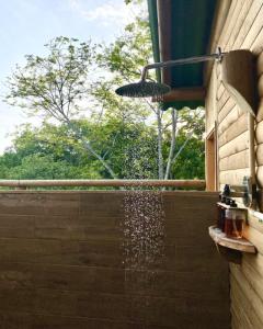 a shower with water coming out of a wall at Ankua Eco Hotel in Usiacurí