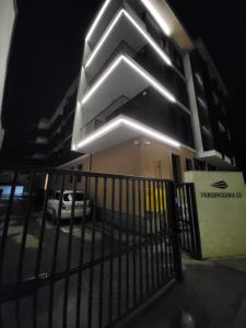 a building with a fence in front of it at night at Proximus in Sremska Mitrovica