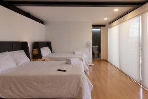 sypialnia z 2 łóżkami z białą pościelą w obiekcie El Doce by HomiRent w mieście Laborcillas