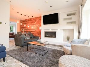 a living room with a brick wall at Haven in Lytham St Annes