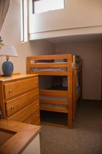a bedroom with a bunk bed and a desk and a bunk bed at Surfcrest Resort in Copalis Beach