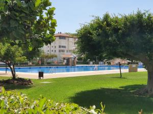 a park with a swimming pool and trees and a building at Casa Alegria - Laguna Beach in Torrox Costa