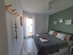 a bedroom with a bed and a window at Casa Alegria - Laguna Beach in Torrox Costa +30 photos