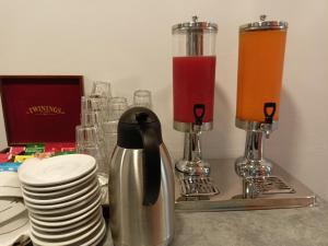 a kitchen counter with a blender and plates and cups at Hotel Ariston Imperial in Porto Garibaldi