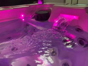 a purple sink with a pink water faucet at Aparthotel Des 2 Caps in Ambleteuse