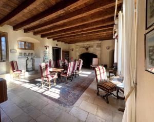 a living room with a table and chairs at Castle in the beautiful French countryside with all modern comfort in Terrou