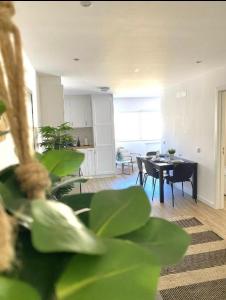 a living room with a table and a dining room at NayJay Staycation in Portimão