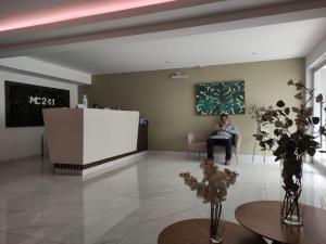 a woman sitting in a chair in a waiting room at MWhite'sHome in Lima