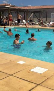 a group of people swimming in a swimming pool at JASSE CAMARGUAISE 535 - PISCINE CLIM PARKING FAMILLE - TOP PROS SERVICESConciergerie in Gallargues-Le-Montueux