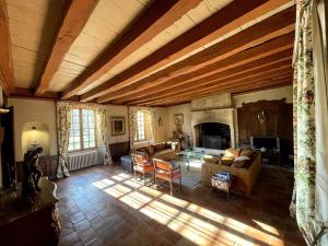 a large living room with a couch and a fireplace at Castle in the beautiful French countryside with all modern comfort in Terrou