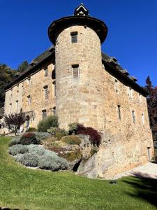 a large brick building with a tower on top at Castle in the beautiful French countryside with all modern comfort in Terrou