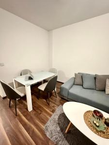 a living room with a couch and a table at Penthouse one bedroom with a view of Zagreb in Zagreb