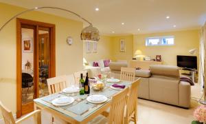 a dining room and living room with a table and chairs at Merewood Lodge in Ambleside