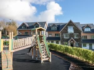 a wooden playground in front of a house at 4 Court Terrace, Hillfield Village in Dartmouth