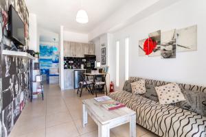 a living room with a couch and a table at Alternative Plan in Ierapetra