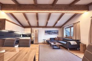 a living room with a couch and a kitchen at Haus Josef-Herold-Straße 17a in Kitzbühel