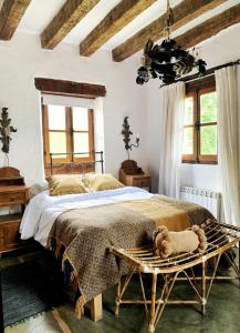 a bedroom with a large bed with a wooden headboard at Castillo de Piedra Tafi del Valle in Tafí del Valle