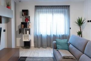 a living room with a couch and a window at Casa Medici in Asti