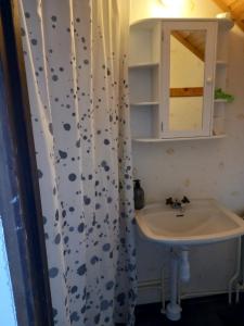 a bathroom with a sink and a shower curtain at Arvika, Centralt in Arvika