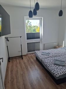 a bedroom with a bed and a window at Apartament Oporowska 22A in Kutno
