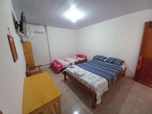 Ein Bett oder Betten in einem Zimmer der Unterkunft Hotel CHAFO