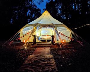 a large tent is lit up at night at Eversprings Glamping in Mount Helena