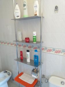 baño con estanterías, artículos de aseo y lavamanos en Room in Guest room - Double Room in Chalet in Toledo, en Toledo