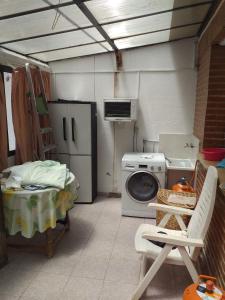 a laundry room with a washing machine and a stove at Room in Guest room - Double Room in Chalet in Toledo in Toledo