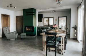 a kitchen and dining room with a table and chairs at Koło Wody in Strzelce +13 photos